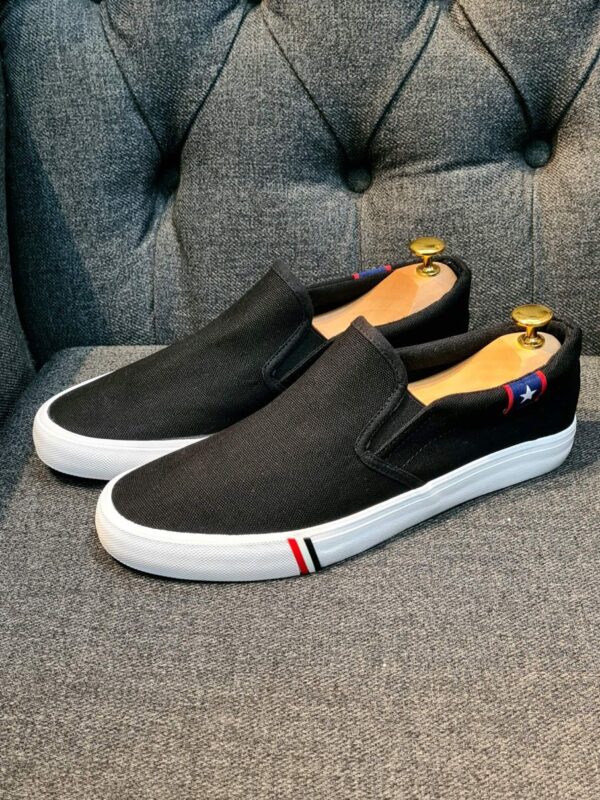 slip on black and white rubber shoe
